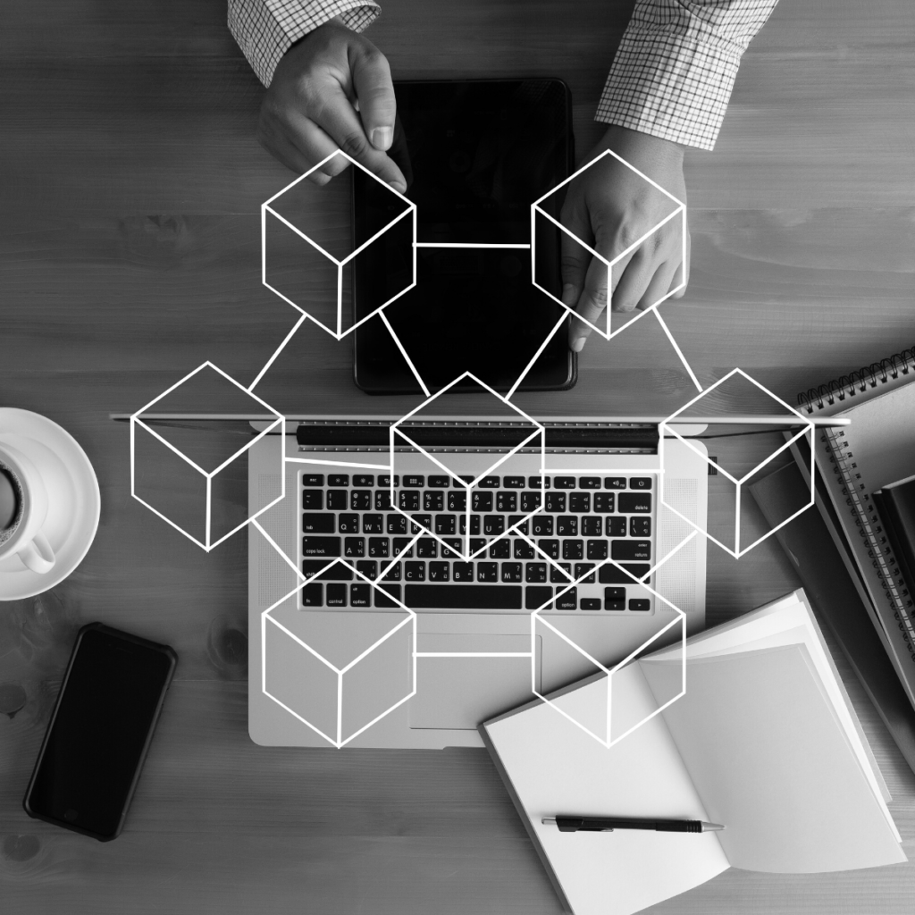 Birdseye view of desk with blockchain graphic overlay